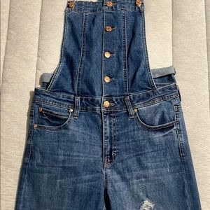 Distressed denim overalls